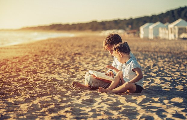 Children Reading on the Beach