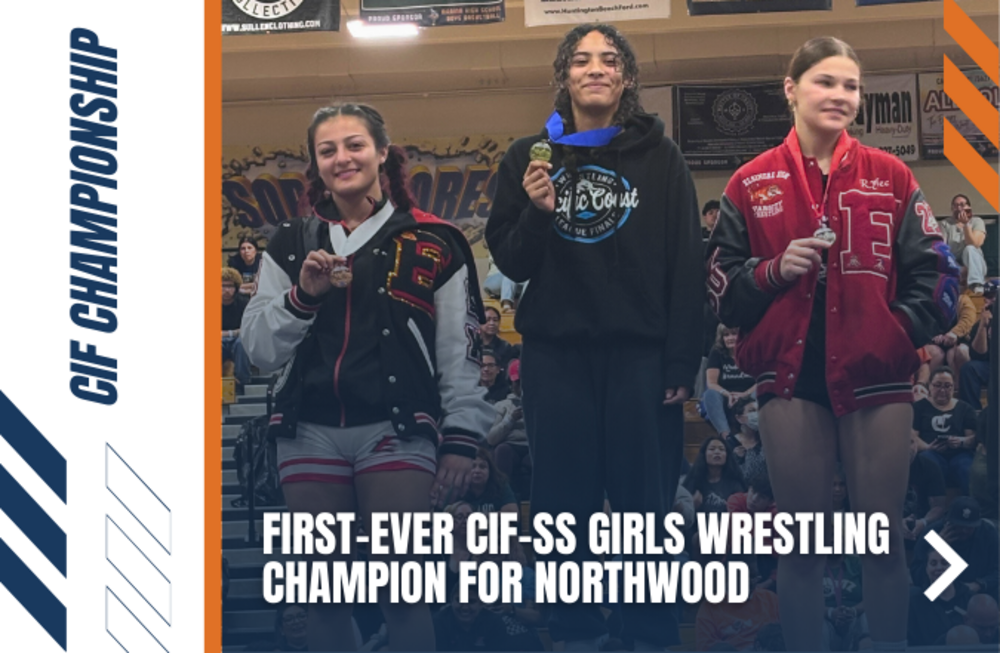 Three young women stand on a podium, each holding a medal, celebrating a wrestling championship.