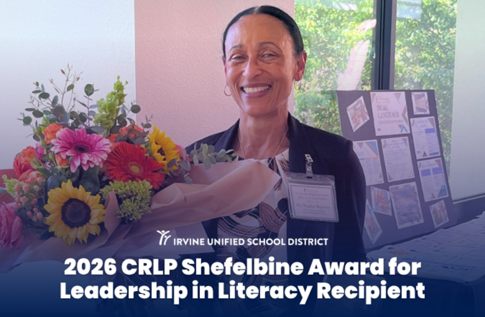 Dr. Natalie Baptiste smiles, holding a large bouquet of colorful flowers and a book, recognized as the 2026 CRLP Shefelbine Award for Leadership in Literacy Recipient.