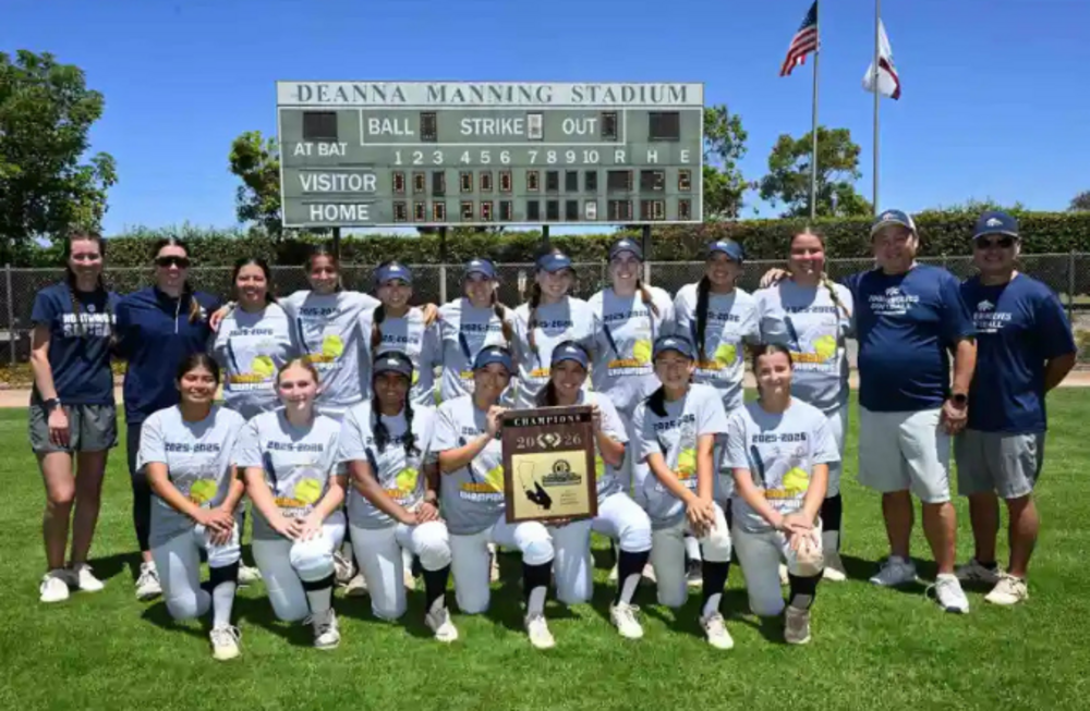A softball team celebrates their Division 5 CIF-SS Championship win, holding trophies and wearing their uniforms.