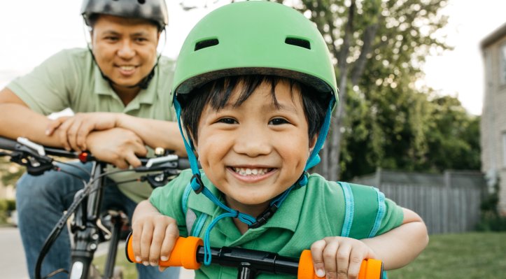 Boy with father helmet safety
