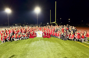 WHS Entertainment Corps posing with championship banner