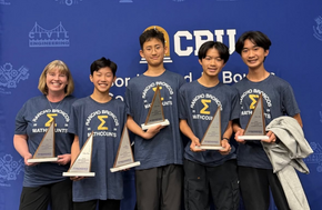 Rancho students and teacher holding awards in front of backdrop