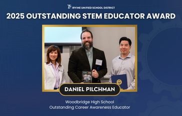 Three educators stand together, celebrating an award for STEM education.