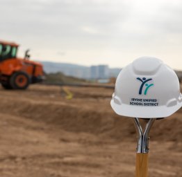 iusd construction hat in front of site