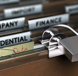 This image shows several rows of hanging file folders in a drawer, focused on a folder labeled CONFIDENTIAL with a padlock on it