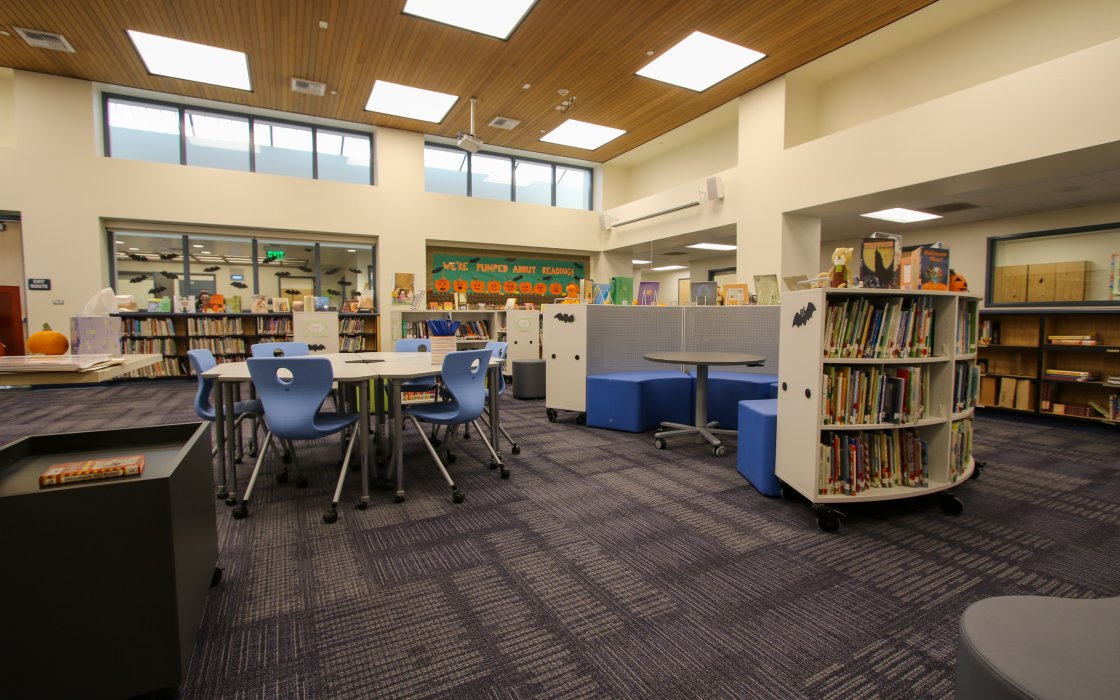 Media center with chairs, desks, and books