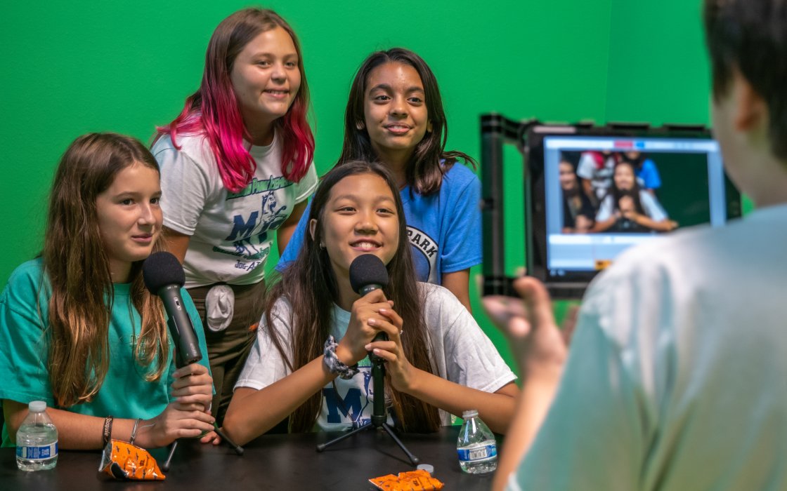 students in a green screen room