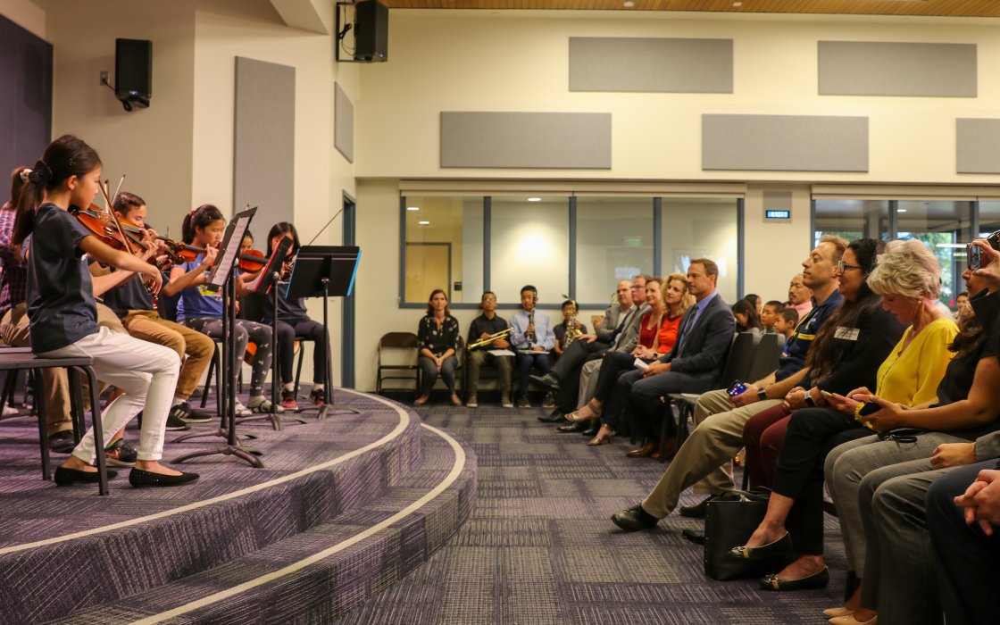 student orchestra performing for audience
