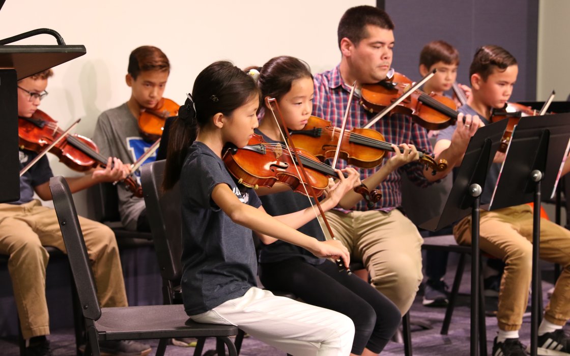 student orchestra performing, violins, violas, cello