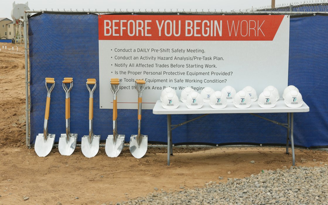 Ceremonial shovels and hard hats lined up