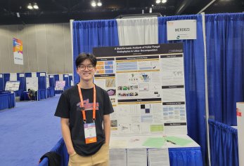 Matthew Chang in front of project