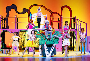 Cast members perform a lively musical number in Irvine High School’s Seussical with colorful costumes and hula hoops.