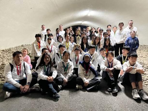 Sierra Vista MS team proudly poses with a trophy and medals, celebrating their achievement.