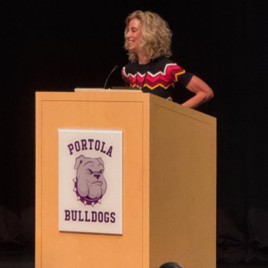 Cassie Parham standing at podium and smiling