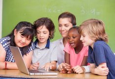Children looking on laptop together